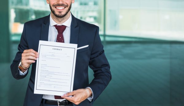 close-up-smiley-lawyer-holding-contract